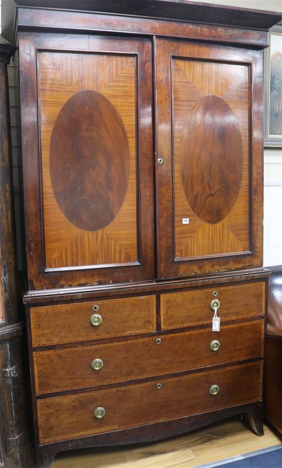 An early 19th century cross-banded mahogany linen press, H.211cm